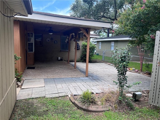 view of patio featuring ceiling fan and a carport