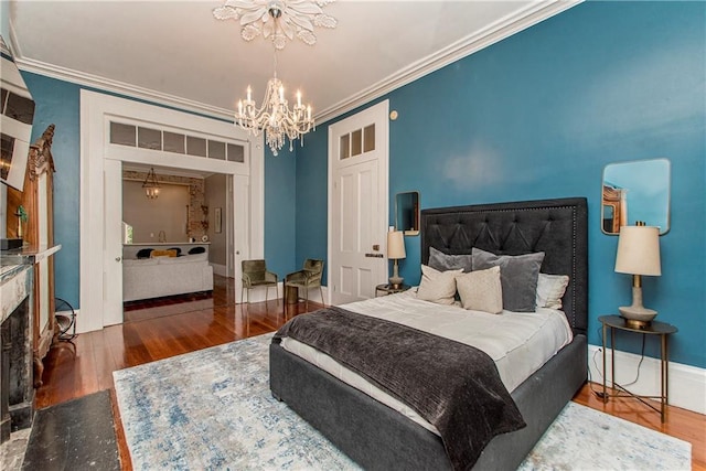 bedroom with dark wood-type flooring, ornamental molding, and a notable chandelier