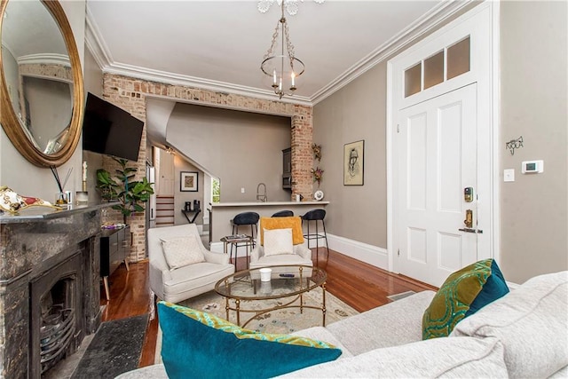 living room featuring sink, dark wood-type flooring, and ornamental molding