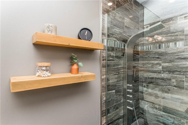 bathroom featuring a shower with door