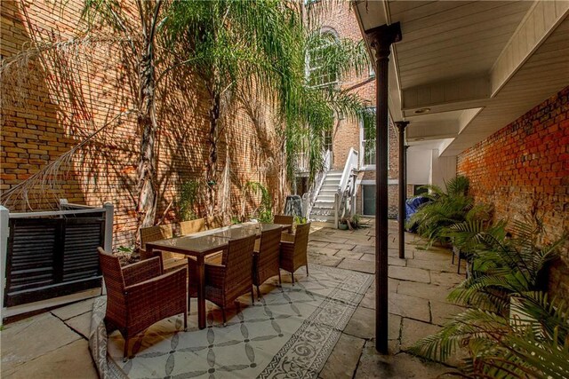604 Esplanade Ave Unit 101, New Orleans, LA 70116 - view of patio with outdoor dining area and stairway