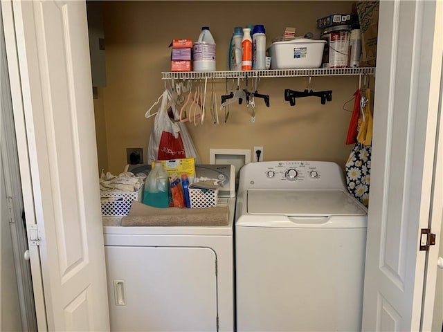 clothes washing area with washer and clothes dryer