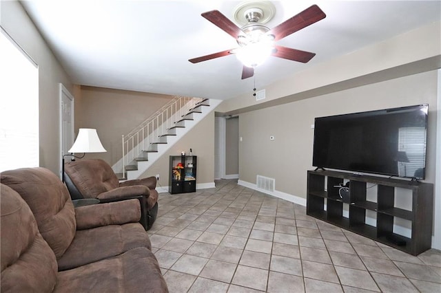 living room with ceiling fan and light tile patterned flooring