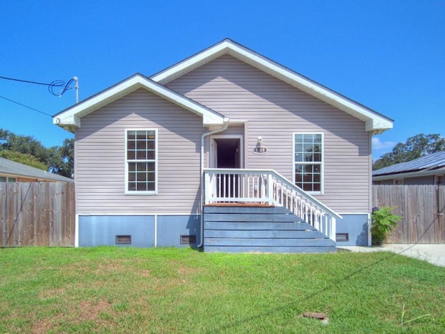 rear view of property with a yard