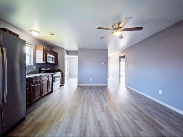 kitchen featuring sink, hardwood / wood-style floors, ceiling fan, and appliances with stainless steel finishes