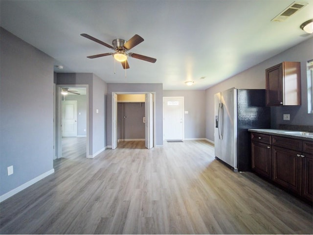 kitchen featuring dark brown cabinets, light wood-type flooring, and stainless steel fridge with ice dispenser