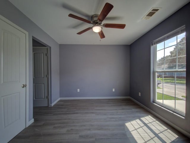 spare room with hardwood / wood-style floors and ceiling fan