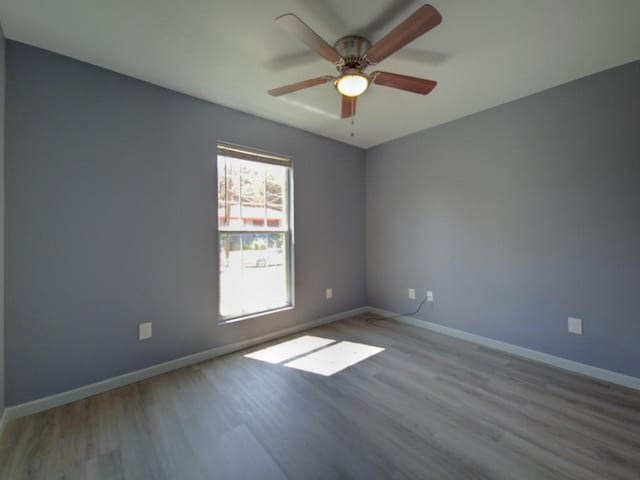 empty room featuring ceiling fan and light wood-type flooring