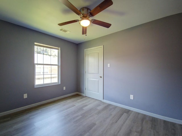 spare room featuring ceiling fan and light wood-type flooring