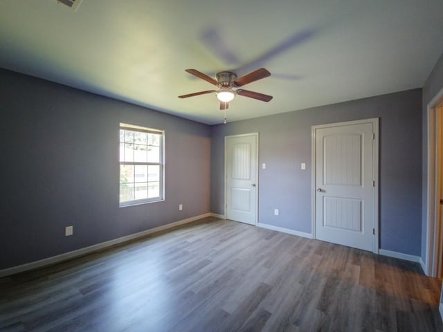 unfurnished bedroom with hardwood / wood-style floors and ceiling fan