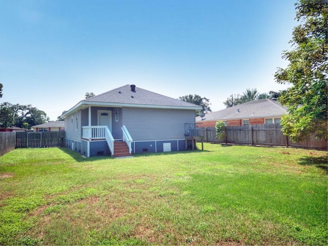 rear view of property with a lawn