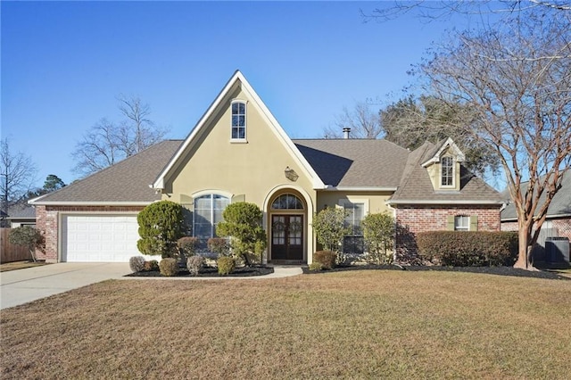 view of front of home with a garage, a front lawn, and french doors