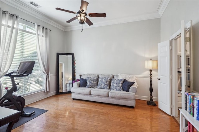 living room with hardwood / wood-style flooring, ornamental molding, a healthy amount of sunlight, and ceiling fan