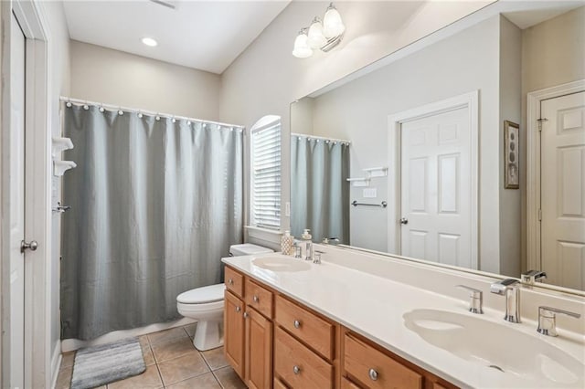 bathroom featuring vanity, tile patterned floors, and toilet