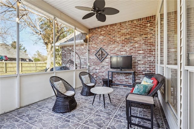 sunroom / solarium featuring ceiling fan