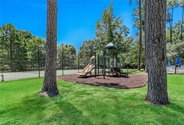 view of jungle gym featuring a yard and tennis court