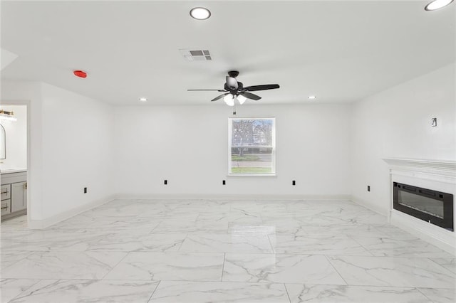 unfurnished living room featuring marble finish floor, visible vents, and recessed lighting