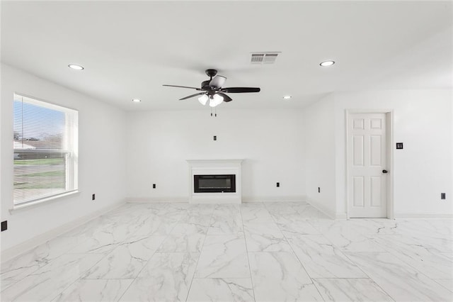 unfurnished living room featuring ceiling fan, recessed lighting, visible vents, baseboards, and a glass covered fireplace