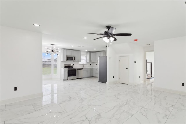 unfurnished living room with marble finish floor, ceiling fan with notable chandelier, baseboards, and recessed lighting