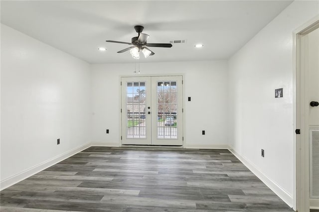 spare room featuring baseboards, visible vents, wood finished floors, and french doors