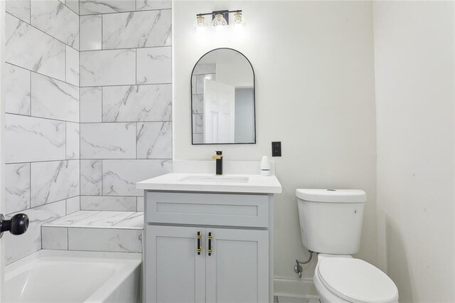 bathroom featuring toilet, tub / shower combination, and vanity