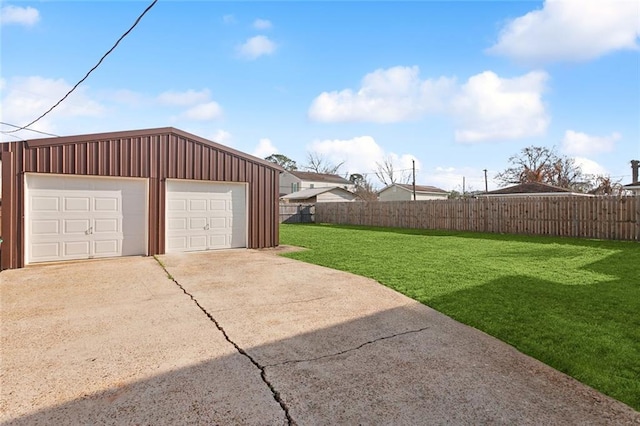 view of yard with an outbuilding, fence, and a detached garage