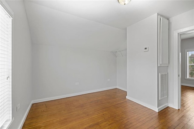 bonus room with lofted ceiling and hardwood / wood-style flooring