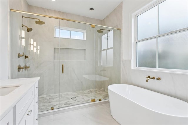 bathroom featuring shower with separate bathtub and vanity