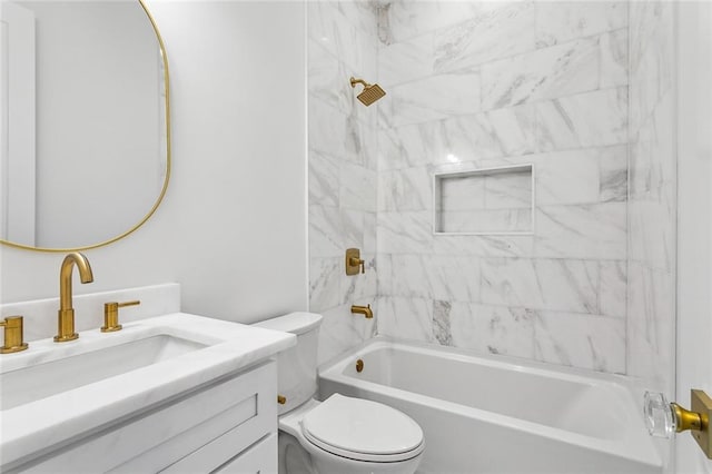 full bathroom featuring tiled shower / bath combo, vanity, and toilet