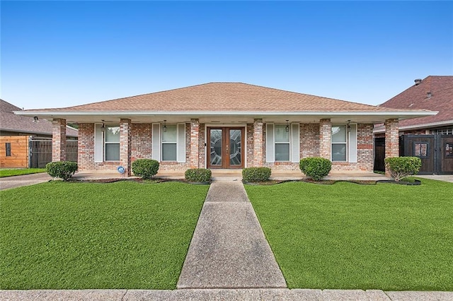 ranch-style house featuring brick siding, a porch, and a front lawn