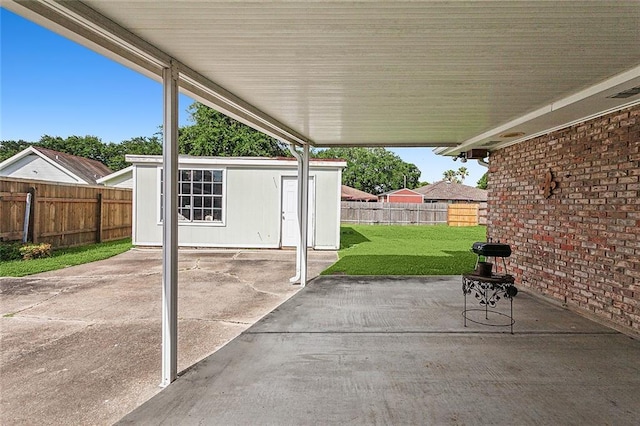 view of patio featuring an outbuilding and a fenced backyard