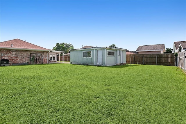 view of yard featuring an outbuilding and a fenced backyard