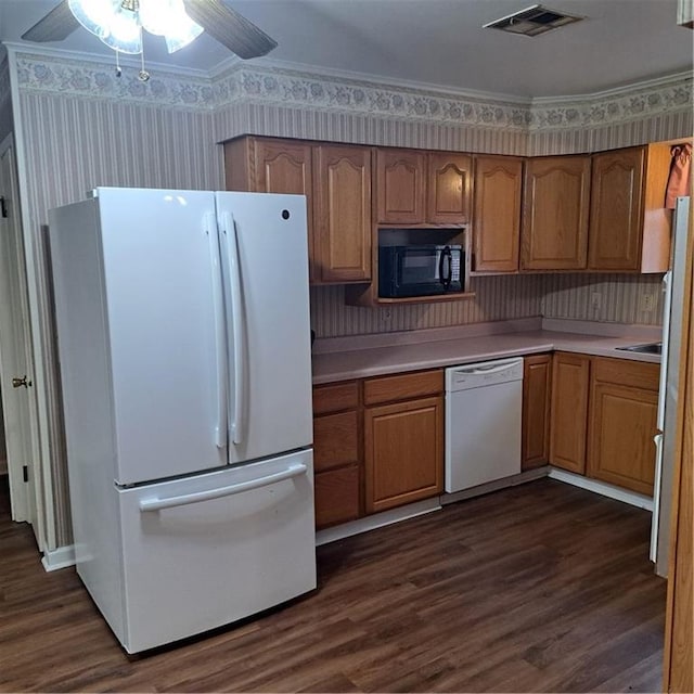 kitchen featuring dark hardwood / wood-style flooring, white appliances, crown molding, and ceiling fan