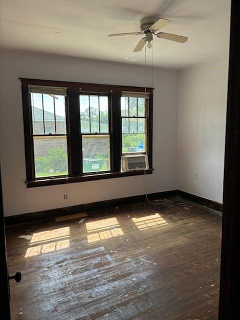 spare room featuring cooling unit, dark wood-type flooring, and ceiling fan