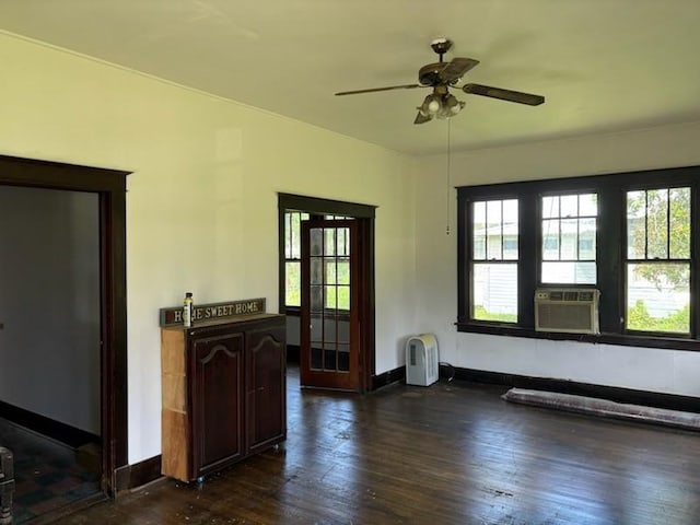 spare room featuring cooling unit, ceiling fan, and dark hardwood / wood-style flooring