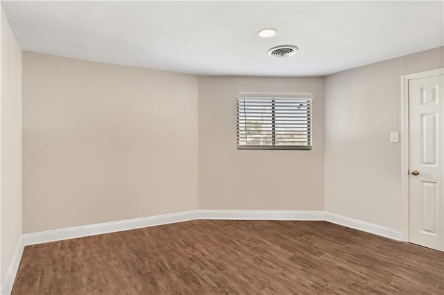 spare room featuring dark hardwood / wood-style floors