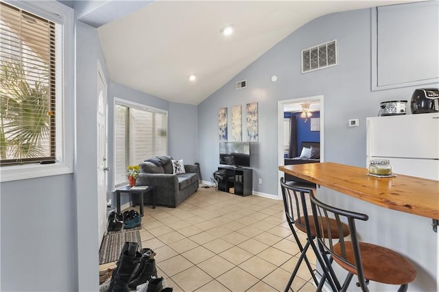 kitchen featuring light tile patterned flooring and lofted ceiling