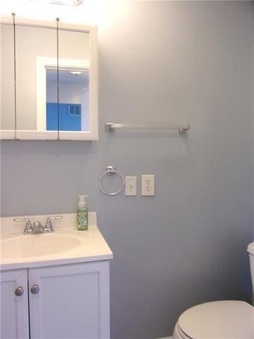 bathroom featuring vanity and toilet