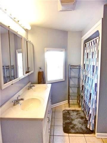 bathroom with tile patterned flooring and vanity