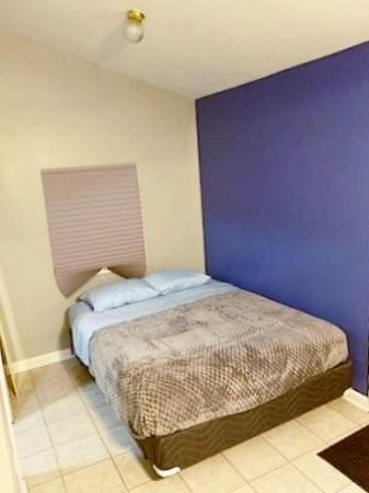 bedroom with light tile patterned floors