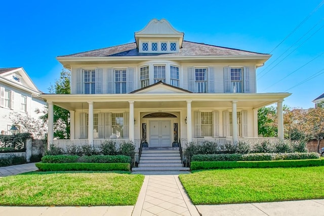 view of front of property featuring a porch and a front lawn