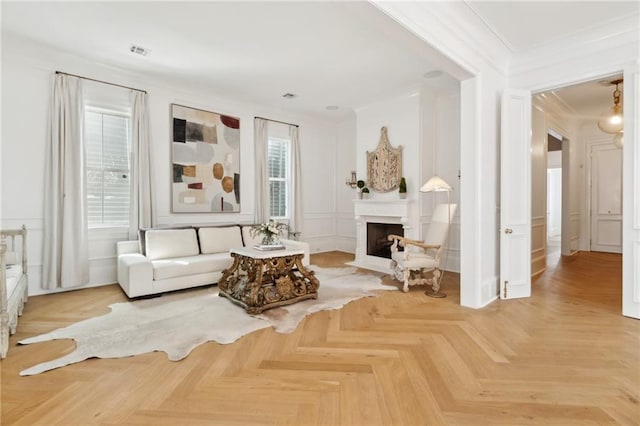 living room with ornamental molding and light parquet floors