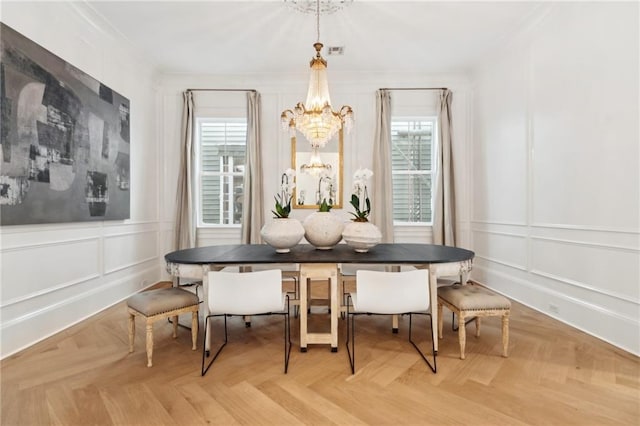 dining space featuring light parquet flooring, an inviting chandelier, and breakfast area