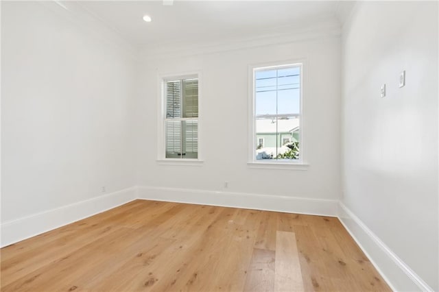 unfurnished room with hardwood / wood-style flooring and ornamental molding