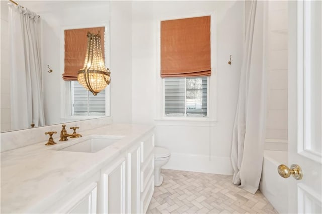 full bathroom featuring shower / bathtub combination with curtain, vanity, and toilet