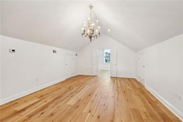 additional living space featuring lofted ceiling and light hardwood / wood-style flooring