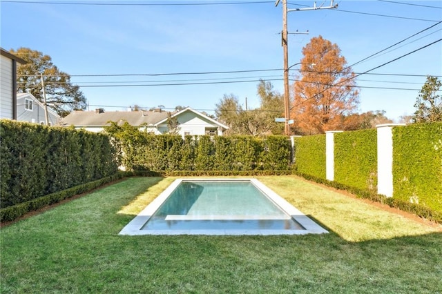 view of pool with a lawn