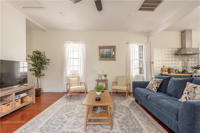 living room featuring ceiling fan and dark hardwood / wood-style floors