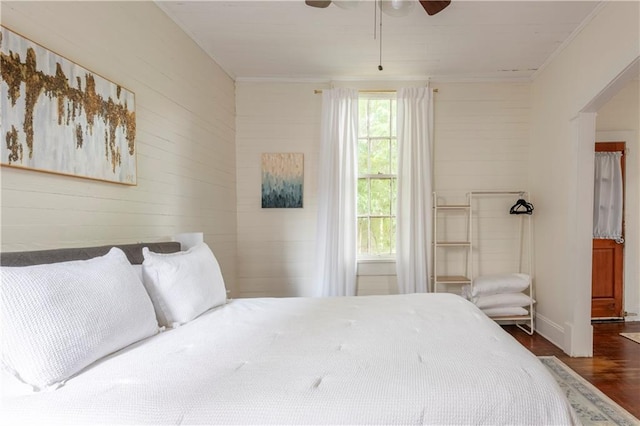 bedroom featuring ceiling fan, ornamental molding, and dark hardwood / wood-style floors