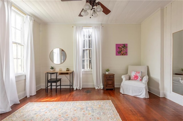 sitting room featuring hardwood / wood-style flooring, ceiling fan, and crown molding